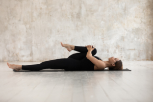 Woman,Wear,Black,Sport,Clothes,Lying,On,Floor,Practising,Asana